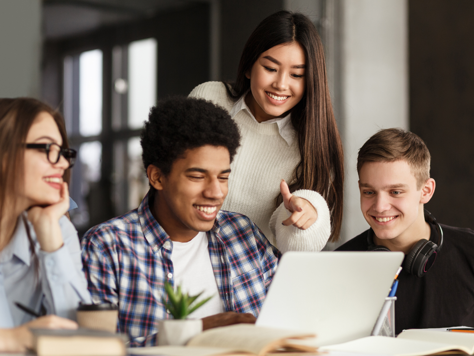 group of students around a laptop