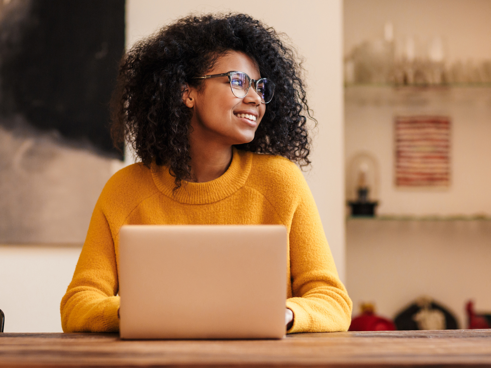 woman at a laptop looking away
