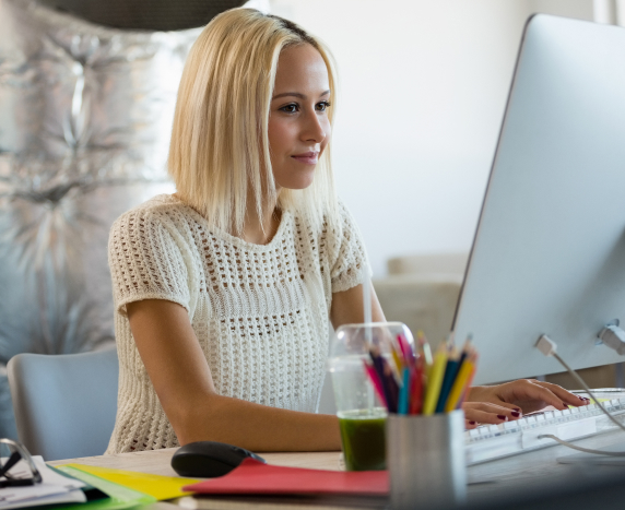 young woman using computer at office