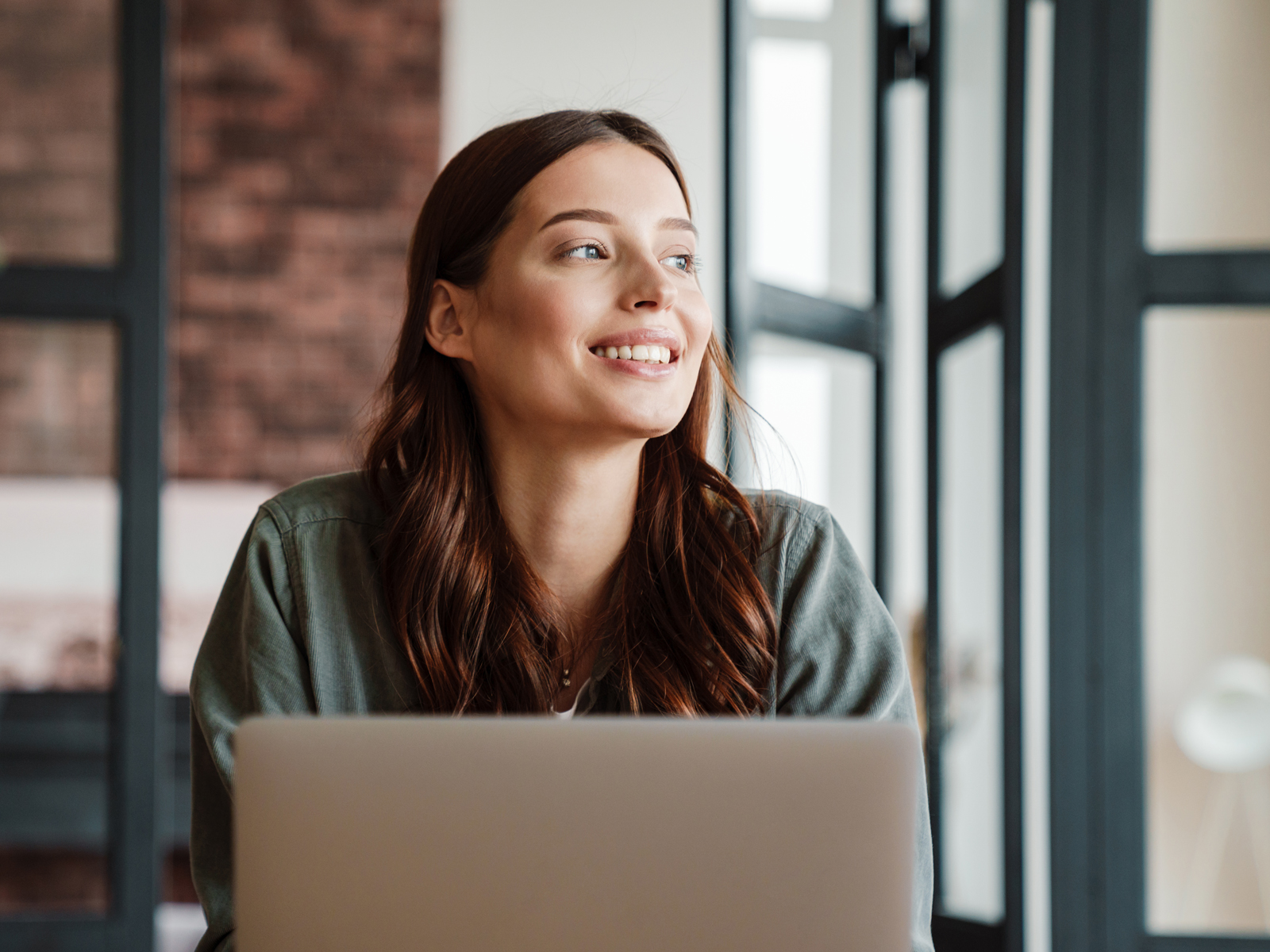 Woman on laptop looking away